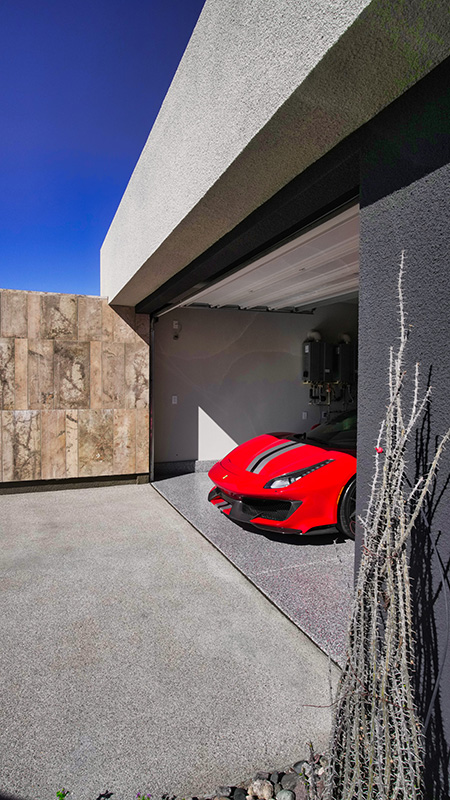garage with garage floor coating and red car