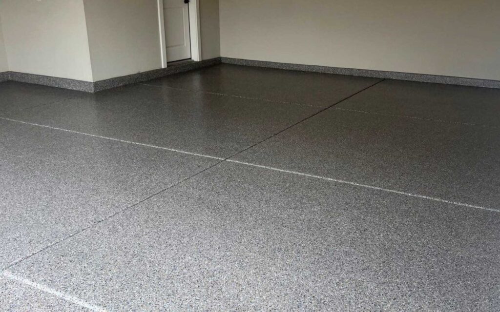 Standard epoxy garage floor coating with gray flake finish installed in a residential garage in Las Vegas