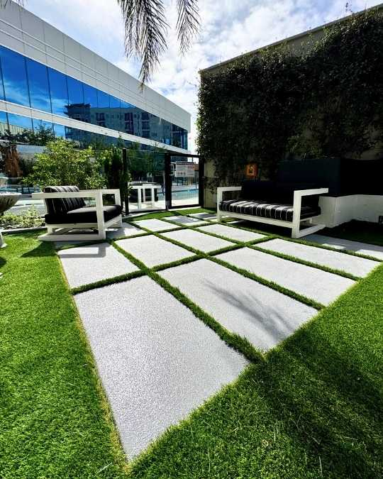 Quartz concrete walkway and patio coating installed at a commercial property in Las Vegas with turf inlays