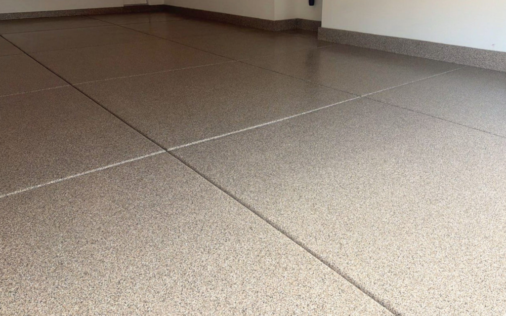 Epoxy garage floor coating with tan flake finish installed in a residential garage in Las Vegas